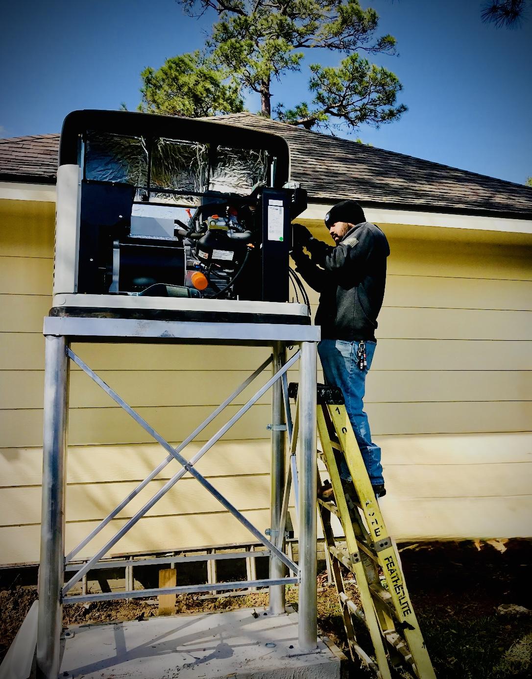 Kelm technician working on an elevated standby generator